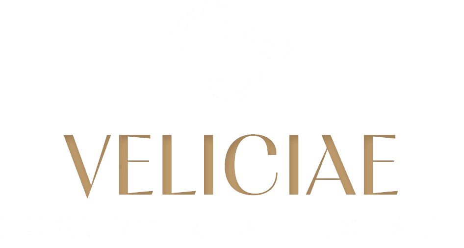 The Veliciae Luxury Real Estate logo in white and gold lettering